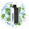 Pod-style vape device with white and black body, surrounded by mint leaves and splashing water to convey freshness and flavor.